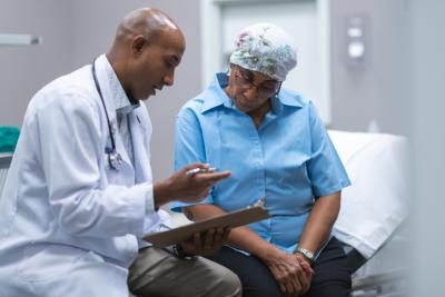 Minority Health Comment Letter 1173367836 A doctor consults with a patient with cancer.