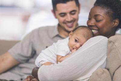 Young family holding their baby