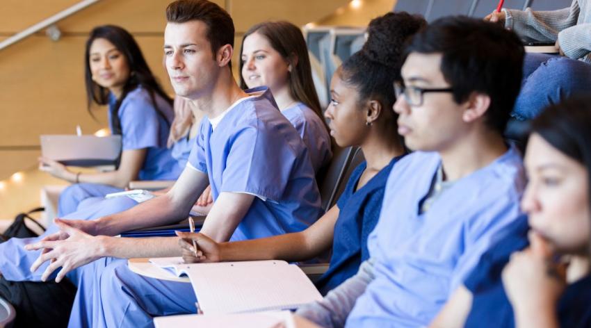 Medical students listen closely at a lecture