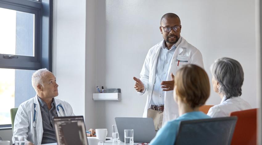 Medical expert giving presentation during meeting