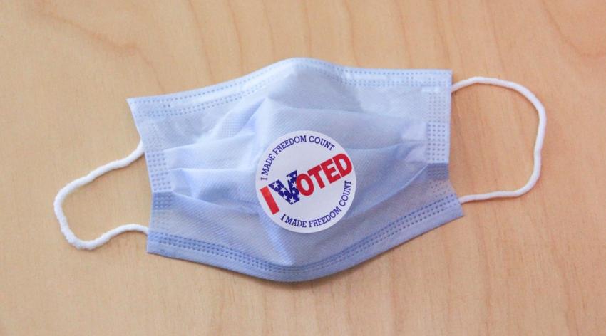 Blue medical max with sticker that says "I voted"