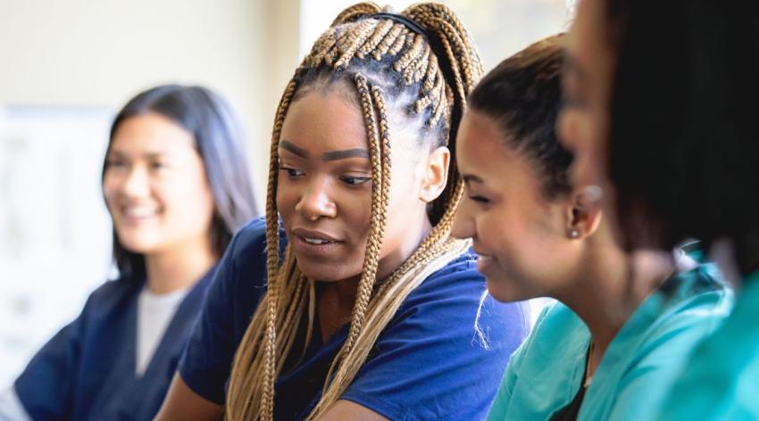 A diverse group of medical students works together on a project.