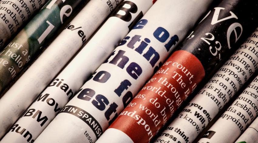 Close-up of a diagonal row of newspapers and magazines