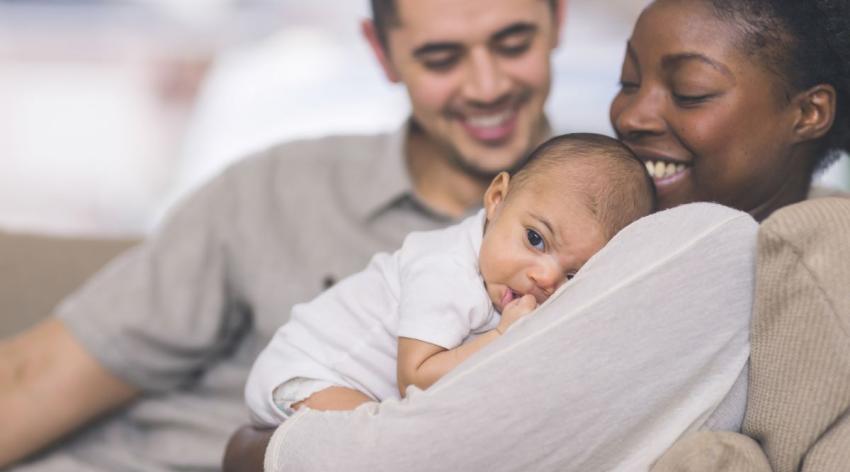 Young family holding their baby